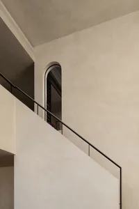 A minimalist staircase constructed from concrete, featuring sleek lines and a minimalist design.