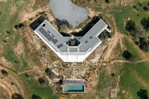Aerial view of a modern residential building with a concrete exterior and geometric design.