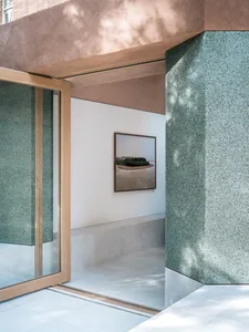 Modern entryway featuring a terrazzo flooring and minimalist design.