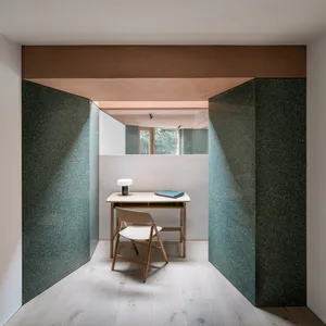 Modern office space featuring a desk, chair, and lamp with minimalist design elements.