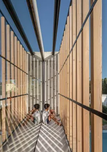 Modern home exterior featuring wood panels and large glass windows.