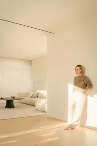 A minimalist residential interior featuring neutral tones and light-filled spaces.