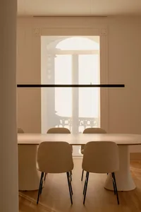 Modern minimalist dining room with clean lines, neutral tones, and a sleek, contemporary table and chairs.