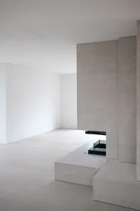 Modern minimalist empty room featuring polished concrete floor and walls.