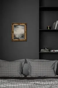 A bedroom with black walls and a wooden bed frame, adorned with black and white checked bedding, a framed abstract painting,