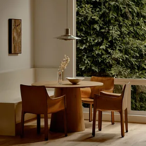 Industrial-style dining table and chairs in a residential setting.