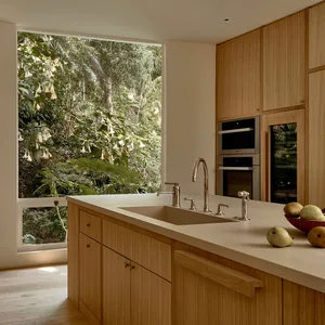 Modern kitchen with wooden cabinets and island.