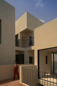 Modern building exterior with concrete walls and black metal railings