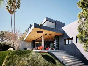 Modern house with concrete and glass exterior, featuring a sleek design.