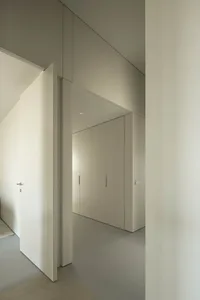 A modern minimalist closet with grey materials and sleek design.