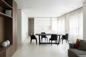 Modern minimalist kitchen with white cabinets, sink, and countertop.