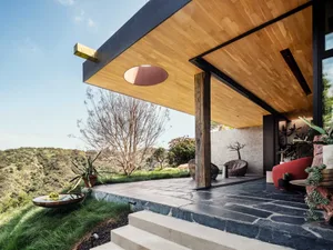 A modern terrace featuring wood, stone, and metal materials.