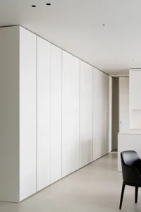 A modern interior with white paneled walls and minimalist design.