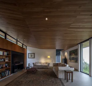 A modern living room featuring wooden construction and upholstered furniture.