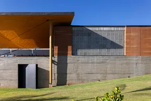 Modern minimalist architecture featuring a structure with concrete walls and a glass grid