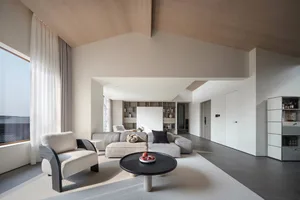 A minimalist living room featuring a concrete flooring.