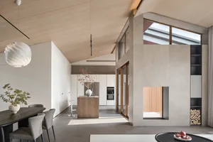 Contemporary living and dining area with minimalist design, featuring a mix of wood, concrete, and glass materials.