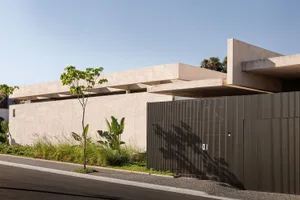 A modern residential exterior with a concrete and steel construction.