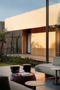 Modern living room featuring concrete and wooden materials with a sleek, contemporary design.