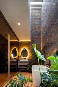 Modern minimalist bathroom featuring wood, stone, and glass materials