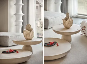 Modern minimalist concrete and ceramic living room furniture with a geometric vase centerpiece.