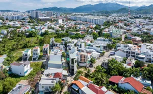 Aerial view of a densely populated urban residential area with various building types and green spaces.