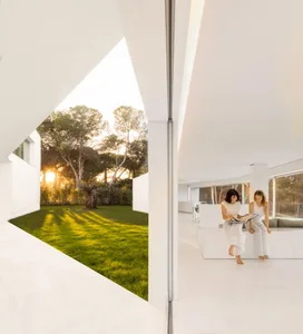 Modern minimalist living room with white marble surfaces and floor.