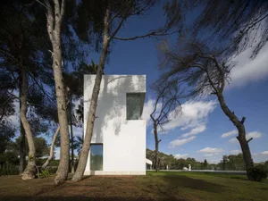 A sleek, modern residential home made of white materials.