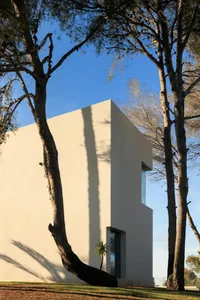 Concrete exterior of a modernist building with a single window.