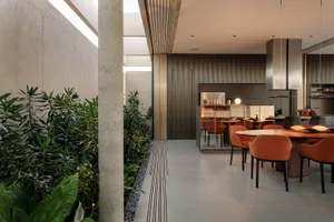 A modern living room featuring exposed concrete walls and steel beams.
