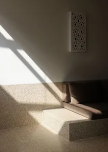 A sunlit corridor featuring tiled flooring and natural light.