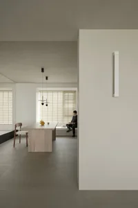 A minimalist flat with concrete walls and flooring.