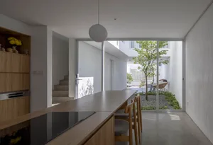 Modern interior design featuring concrete, wood, and glass materials.