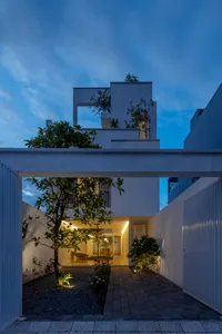 Modern residential house with concrete masonry exterior at dusk.