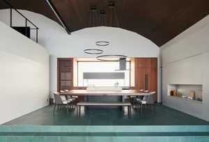Minimalist residential kitchen featuring wooden cabinets and porcelain countertops.