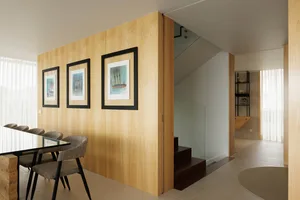 A modern minimalist interior with wooden walls and a glass staircase.