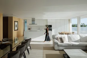 A modern residential kitchen with white cabinets and a white countertop.