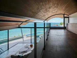 Modern residential space featuring wood, glass, and concrete materials.