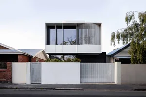 Modern, minimalist urban house with concrete and glass exterior.