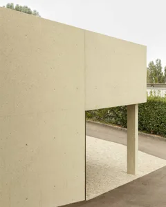 Minimalist building exterior constructed of concrete, featuring clean lines and a flat roof.