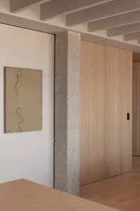 Modern minimalist interior design with concrete pillar and wooden paneling