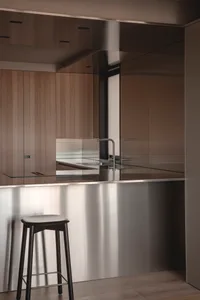 A modern kitchen featuring a metallic countertop and minimalist design.