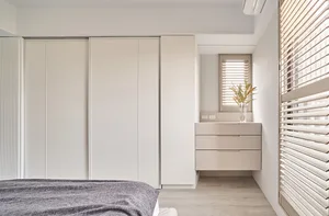 Modern minimalist bedroom featuring wooden furniture and light, neutral color palette