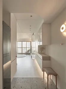 A modern minimalist interior featuring wood flooring and glass elements.