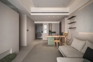 Minimalist living room with concrete floor, white walls, and a kitchen counter.