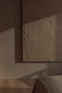 A textured wall in a minimalist bedroom setting.
