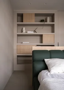 Modern minimalist bedroom with concrete walls and wooden furnishings