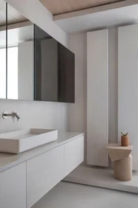 Minimalist bathroom with concrete walls, floating vanity, and sleek design.