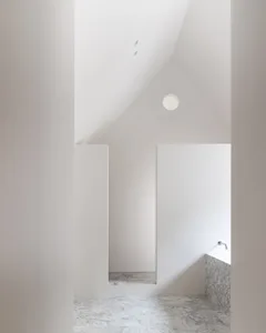 Modern minimalist bathroom with marble flooring and walls.