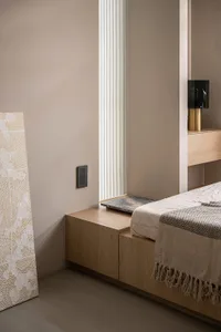 A minimalist bedroom featuring wooden furniture with a modern design.